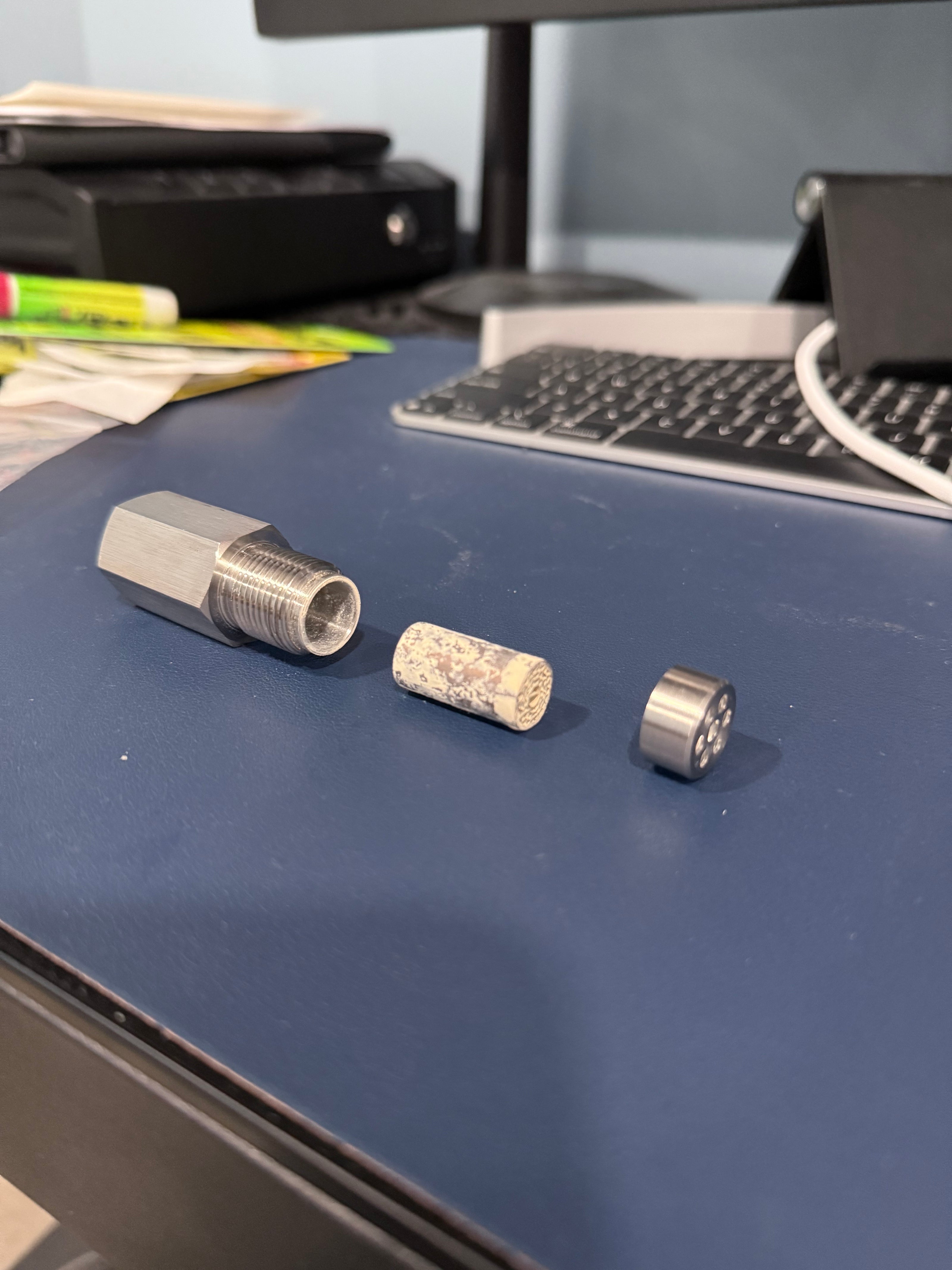 Metallic connectors on a blue surface with a blurred background